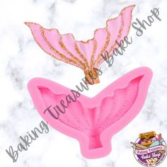 two pink mermaid tail shaped cookie cutters with gold sequins on the side