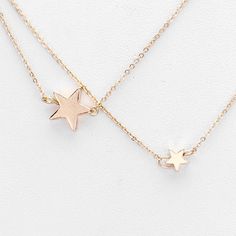 Stay stylish with this delicate triple layers of chain and stars. Color: Worn Gold Necklace 16" + 3" Decor Size 2 1/4" Weight 0.4 oz Imported Star Charm Layered Necklace As Gift, Gift Layered Necklace With Star Charm, Adjustable Star-shaped Necklace With Delicate Chain, Star-shaped Layered Necklace Gift, Gold Star Necklace, Star Necklace Gold, Gold Star, Star Necklace, Gold Stars