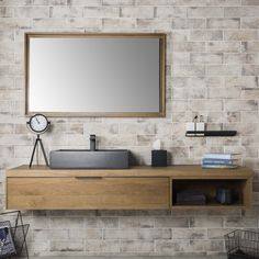 a bathroom with a sink, mirror and shelf