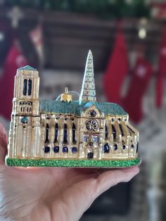 a miniature model of a building with a clock on it