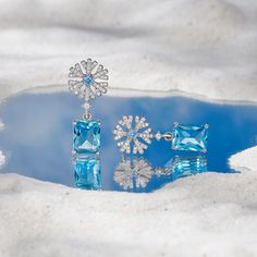 Every winter, we look forward to the first sight of a snowflake. Enjoy the beauty year-round with these bewitching sterling silver snowflake earrings. Polished metal and glittering stones come together to create this unique jewelry, for a sophisticated yet sparkling look. Wear these drop earrings while gathering by the fireplace in winter holidays, or simply to feel cooler on a hot summer day, or just to add a touch of wintry magic to your everyday look. Polished to a brilliant shine, these piec Elegant Snowflake Earrings For Parties, Formal Snowflake Sterling Silver Jewelry, Sterling Silver Snowflake Earrings, Formal Sterling Silver Snowflake Jewelry, Snowflake Sparkling Earrings For Gift, Cubic Zirconia Snowflake Earrings For Gift, Silver Snowflake Earrings For Anniversary, Silver Snowflake Earrings For Pierced Ears, Silver Snowflake Cubic Zirconia Earrings