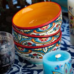 colorful dishes and candles sit on a table