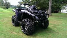 a black four - wheeler parked in the grass