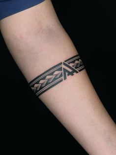 a tattoo on the arm of a person with a black and white pattern around it