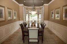 a dining room table with chairs and a chandelier