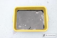 a yellow and black container with water in it