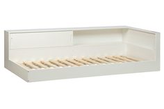 a white bed frame with two drawers on each side and no mattresses in the middle