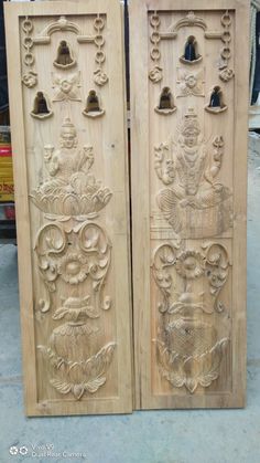 two carved wooden doors with bells on them