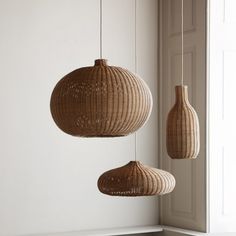 three wicker lamps hanging from the ceiling