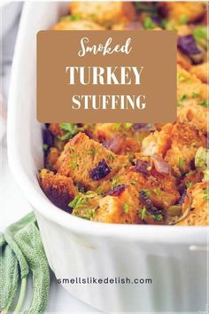 a white casserole dish with stuffing in it and the words smoked turkey stuffing