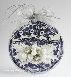 a blue and white ornament with snowflakes on it's side