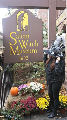 a woman standing in front of salem witch museum