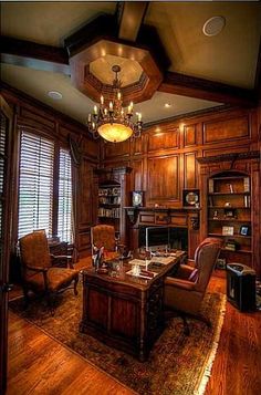 an office with wood paneling and chandelier