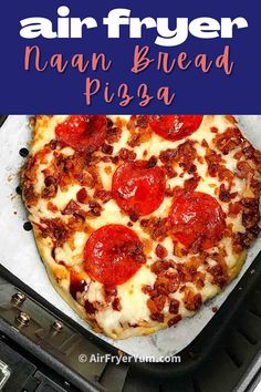 a pizza sitting on top of a pan covered in cheese and pepperoni next to an air fryer