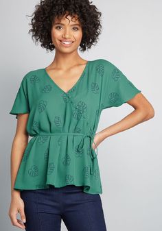 As you make new connections in this green blouse from our ModCloth namesake label, your breezy demeanor mirrors that of its fluttery short sleeves and airy silhouette. A button-detailed surplice neckline, optional slim sash for a peplum effect, and navy blue leaf print ensure every salutation given in this woven top reflects your refinement. Polyester. Hand wash. Semi-sheer. Decorative front buttons. Removable sash. Imported Model is wearing size: 1X S Fabric does not provide stretch. S=26.25 in Vintage Style Swimwear, Form Fitting Clothes, New Connections, Casual Dresses Plus Size, Midi Dress Plus Size, Surplice Top, Tunic Hoodie, Vintage Swimwear, Plus Size Outerwear