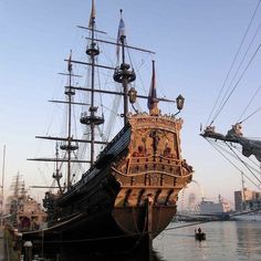 an old pirate ship is docked in the water