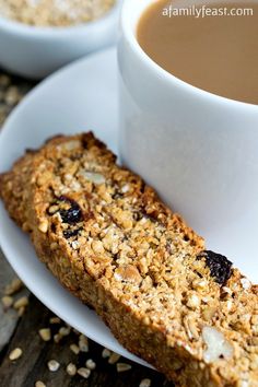 two cups of coffee and some granola on a plate