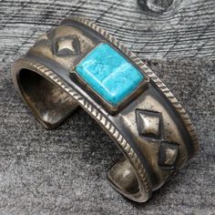 "Hand forged and formed bracelet by Texas artist Mike French. This is an ingot forged bracelet that has been hammered to it's final formwith hand stamped with arrows on each end and filed border. Bracelet has a single pieced of Kingman turqouise in a handmade bezel, The bracelet is 5 1/2"" long and 1"" wide, with a 1"" gap and weighs an incredible 160 grams. " Adjustable Rustic Jewelry With Oxidized Finish, Rustic Adjustable Jewelry With Oxidized Finish, Rustic Hand Cast Adjustable Jewelry, Rustic Adjustable Hand Cast Jewelry, Rustic Turquoise Bracelet Jewelry, Rustic Turquoise Bracelet, Rustic Adjustable Etched Jewelry, Rustic Silver Jewelry With Patina, Forged Bracelet