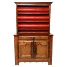 an old wooden bookcase with red leather lining on the top and bottom shelf,