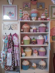 a shelf filled with lots of cupcakes and cakes