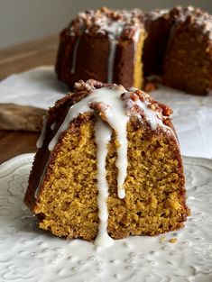 a bundt cake with icing on a plate next to another bundt cake