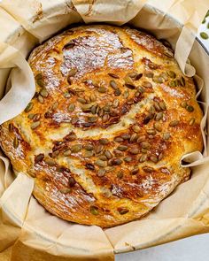 a round bread with pumpkin seeds in it