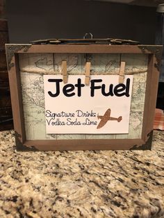 a sign that says jet fuel on the side of a counter with a map behind it