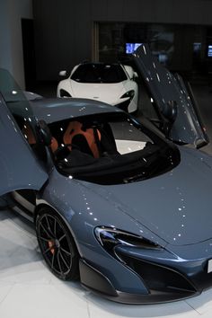 a blue sports car is on display in a showroom