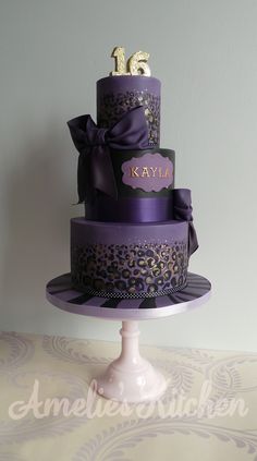 there is a purple cake with leopard print on it and the words can't decide if for my baby?