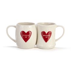 two coffee mugs with red hearts on them