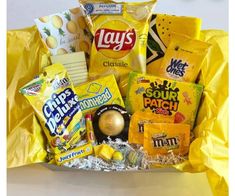 a yellow basket filled with snacks and candy