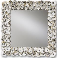 a square mirror with shells on it