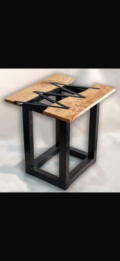 a wooden table with black metal legs and a wood top on the bottom, in front of a white background