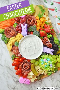 a platter filled with fruit, veggies and dip surrounded by easter decorations