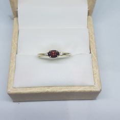 14k solid yellow gold natural oval shaped garnet semi precious gemstone and natural round brilliant cut shaped diamonds gemstones ring. 1. The weight of garnet semi precious gemstone used in the ring =0.56 cts. 2. The weight of natural diamonds gemstones used in the ring =0.04 cts. 3. The weight of 14k solid yellow gold used in the ring =1.180 grms. 4. The garnet is the birthstone for the people born in the month of January. 5. The design of the ring is very nice and beautiful. 6. I have used al Gold Garnet Ring, January Birthstone Rings, Peridot Stone, Garnet Rings, Garnet Gemstone, Rings For Her, Ring Ring, Birthstone Ring, Stackable Rings