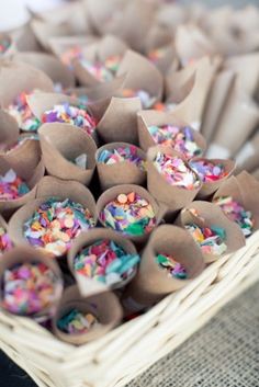 a basket filled with lots of colorful sprinkles on top of a table