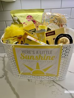 a basket filled with lots of different items on top of a white counter next to a tile wall