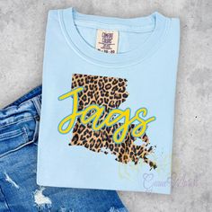 Get ready to roar for the Jaguars in style with our Louisiana Jags t-shirt! This playful design is available in three shirt color options and is made on a unisex Gildan t-shirt. Show your team spirit and choose from three great color options. Go Jags! Lady Games, Bayou Classic, Southern University, Game Day Shirts, Playful Design, Team Spirit, Shirt Color, Game Day, Jaguar