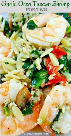 this is an image of pasta with shrimp and spinach