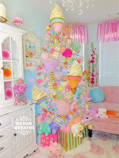 a very colorful christmas tree with ice cream cones and candies on it's top