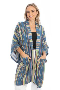 The long silhouette of our colorful Aztec-inspired kimono is comfy and breathable. As an added bonus, this piece has two deep pockets on either side. Materials: 100% Cotton Size: 27” x 44” Made In India Casual Long Multicolor Kimono, Casual Multicolor Long Kimono, Oversized Blue Cardigan With Pockets, Bohemian Outerwear With Pockets Relaxed Fit, Multicolor Summer Outerwear With Pockets, Oversized Multicolor Casual Kimono, Blue Bohemian Outerwear With Pockets, Multicolor Cotton Outerwear For Loungewear, Blue Outerwear For Spring Loungewear