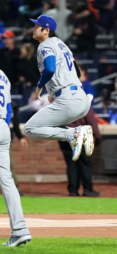 a baseball player is jumping in the air