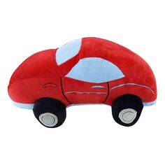 a red car shaped pillow sitting on top of a white floor