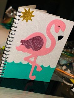 a pink flamingo notebook sitting on top of a table