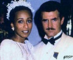 the man and woman are posing for a photo in their wedding day attire, wearing tiaras