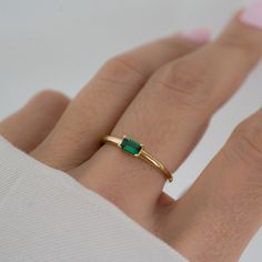 Beautifully crafted emerald ring is a true stunner! Looks great stacked or on its own! - - - D E T A I L S - - -  * Made of 925 Sterling Silver * We use a THICK plating of 14k Gold or Rhodium * Available in sizes 4-10 * 3x5mm Baguette Stone * Nickel-free & Hypoallergenic - Will not turn your fingers green! * Made of the highest grade cubic zirconia for an authentic look! * Also available in White Cubic Zirconia  https://www.etsy.com/listing/1327774787/baguette-ring-dainty-stacking-ring?click_key=1cbb852cd51339c29f8a763fa5c7a3085b2fd29f%3A1327774787&click_sum=b630e565&ga_search_query=baguette%2Bring&ref=shop_items_search_19&pro=1&sts=1 If you're unsure of your ring size, we recommend trying our ring size tool! https://www.etsy.com/listing/1240904225/ring-sizer-reusable-ring-sizer-plastic?cl Gold Emerald Ring Engagement, Modern Green Diamond Promise Ring, Minimalist Emerald Cut Crystal Gemstone Ring, Elegant Green Emerald Cut Stackable Rings, Green Gemstone Stackable Rings For May Birthstone, Classic Green Emerald Cut Stackable Rings, Classic Green Emerald-cut Stackable Rings, Stackable Green Emerald-cut Diamond Ring, Stackable Emerald Cut Green Diamond Ring