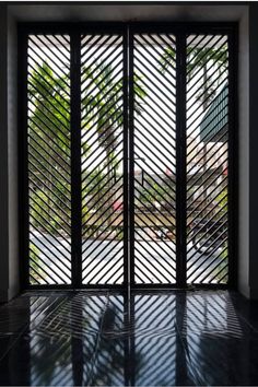 an open window with black slats on the outside