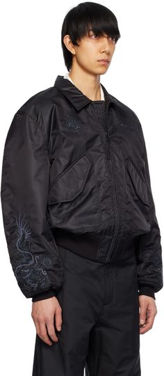 Nylon taffeta bomber jacket. Lightweight, water repellent, and abrasion-resistant. · Spread collar · Zip closure · Logo graphic embroidered at chest and sleeves · Flap pockets · Rib knit cropped hem and cuffs · Logo flag at side seam · Utility pocket at sleeve · Welt pocket at interior · Partially-elasticized quilted shoulder straps at interior · Full taffeta lining Supplier color: Black Functional Gore-tex Outerwear With Pockets, Luxury Men's Single-breasted Utility Jacket, Luxury Single-breasted Men's Utility Jacket, Luxury Garment-dyed Utility Jacket, Luxury Gore-tex Men's Outerwear, Logo Graphic, Flap Pocket, Welt Pocket, Water Repellent