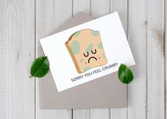 a card with a piece of bread on it that says sorry you feel crumby