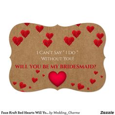 save the date card with red hearts on brown paper and hanging from strings, in front of a white background